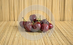 Ripe cherries ready to eat on bamboo hemp tatami in Japan horizontal photo