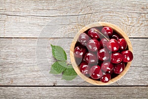 Ripe cherries on wooden table