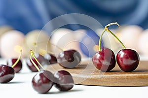 Ripe cherry close-up. Garlands are burning. Wood