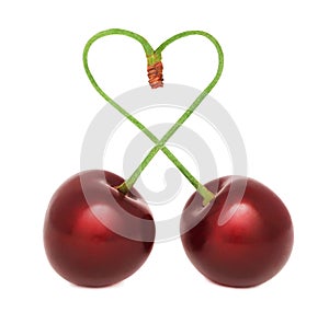 Ripe cherry with stems in the shape of a heart (isolated)