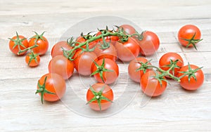 Ripe cherry tomatoes closeup on wooden board