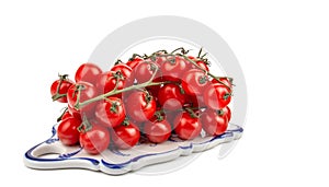 Ripe cherry tomatoes on a vine, three bunches on a white isolated background, space for text