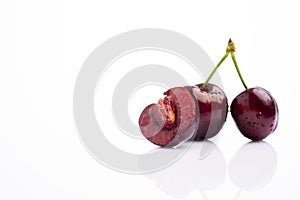 Ripe cherry with water drops on white
