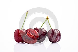 Ripe cherry with water drops on white