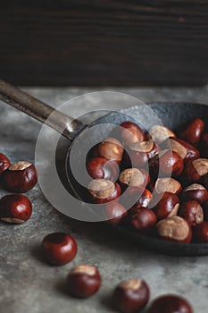 Ripe chestnuts in an old iron pan.