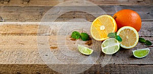 Ripe Citrus Fruit on the Old Wooden Table. Orange, Lime, Lemon Mint. Healthy Food. Summer Background.