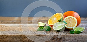 Ripe Citrus Fruit on the Old Wooden Table. Orange, Lime, Lemon Mint. Healthy Food. Summer Background.