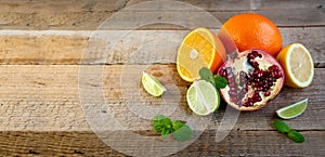 Ripe Citrus Fruit on the Old Wooden Table. Orange, Lime, Lemon Mint. Healthy Food. Summer Background.