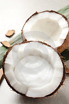 Ripe coconut with cream on light grey table