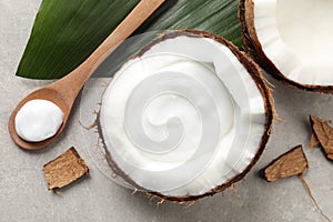 Ripe coconut and cream on light grey table, flat lay