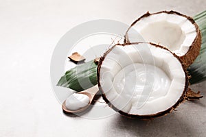 Ripe coconut and cream on light grey table. Space for text