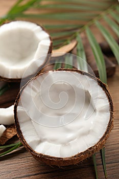 Ripe coconut with cream on wooden table. Space for text