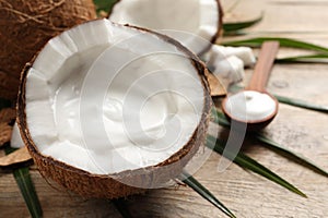 Ripe coconut with cream on wooden table. Space for text
