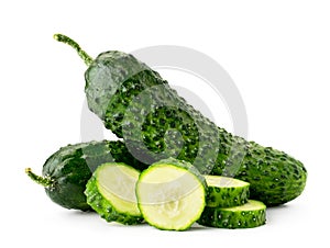 Ripe cucumbers and slices close-up on a white background. Isolated. photo