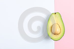 Ripe cut avocado on color background