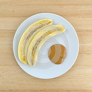 Ripe cut banana and a portion of peanut butter