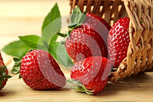 Ripe, delicious strawberries. red berry strawberries in a wicker basket on a natural wooden table