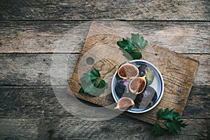 Ripe Figs on cutting board and wooden table