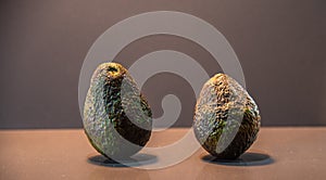 Ripe and fresh avocado fruits Persea americana on dark background
