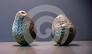 Ripe and fresh avocado fruits Persea americana on dark background