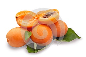 Ripe, fresh, juicy apricots.Green leaves.Apricot halves.Isolated over white background.