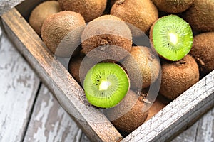 Ripe fresh kiwi fruits in wooden box