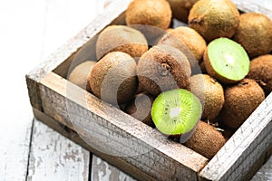 Ripe fresh kiwi fruits in wooden box