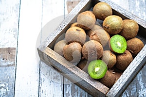 Ripe fresh kiwi fruits in wooden box