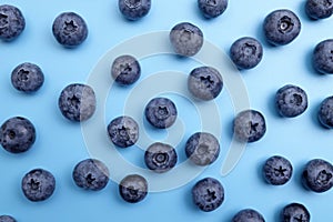 Ripe fresh sweet blueberries on blue background