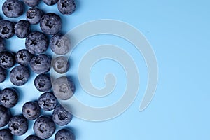 Ripe fresh sweet blueberries on blue background