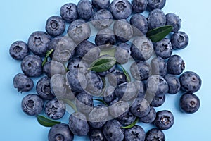 Ripe fresh sweet blueberries on blue background