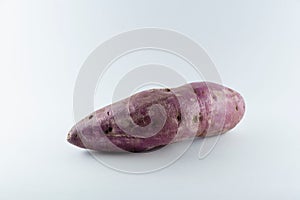 Ripe fresh sweet potato isolated over the white background.