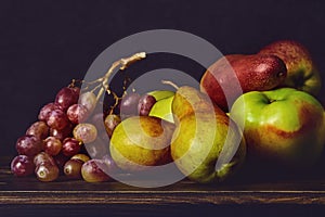 Ripe fruits on a wooden old dark table