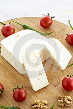 Ripe goat cheese on wooden background. Story format