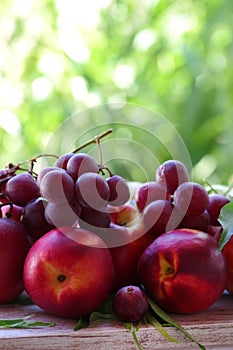 ripe grapes and peaches on table