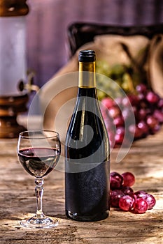 Ripe grapes red wine glass and bottle of wine