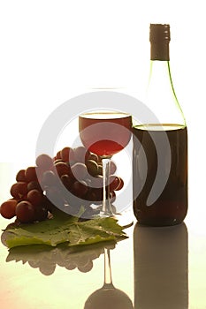 Ripe grapes, wine glasses and bottles of wine corkscrew isolated on white