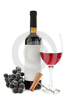 Ripe grapes, wine glasses and bottles of wine isolated on white