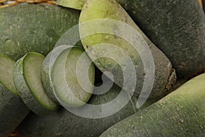 Ripe green daikon radishes as background, closeup