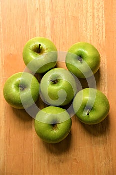 Ripe green Granny Smith apples on wooden background