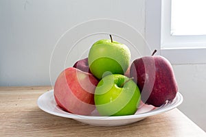 Ripe Green and Red apples on white table background.