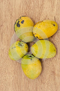 Ripe Green Skin Mangoes On Wooden Background