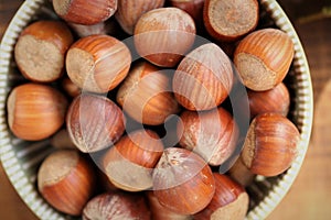 ripe hazelnuts close-up in a cup on a wooden table.Vegetable protein source. Healthy fats. Farmed organic ripe hazelnuts