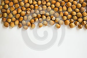 Ripe hazelnuts in a peel on a white background
