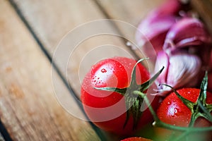 Ripe juicy beautiful tomatoes with water drops on a dark background close-up. Natural texture of vegetables and greens, parsley, o