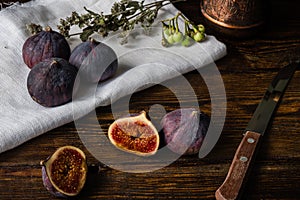 Ripe and juicy figs lying on rustic table.