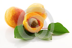 Ripe juicy fruits and green leaves of apricot close up