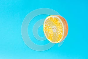 Ripe Juicy Halved Orange Floating Levitating in the Air on Light Blue Background. Vitamins Healthy Diet Summer Detox Vegan