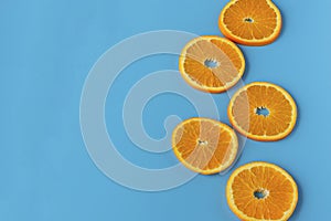 Ripe juicy orange on a blue background. Citrus fruit. Vitamins and Food for Vegetarians.