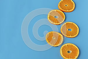 Ripe juicy orange on a blue background. Citrus fruit. Vitamins and Food for Vegetarians. photo